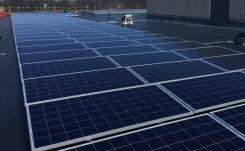 Daytime view of solar panels in a rooftop solar installation on a school in Braintree, Massachusetts.